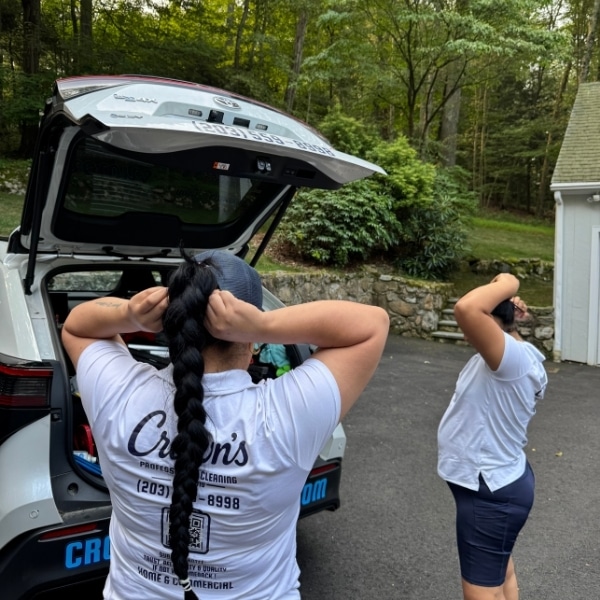 Crown’s cleaning team getting ready for a home visit beside their company vehicle