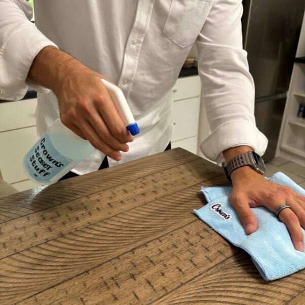 A Crown’s professional carefully cleaning a table